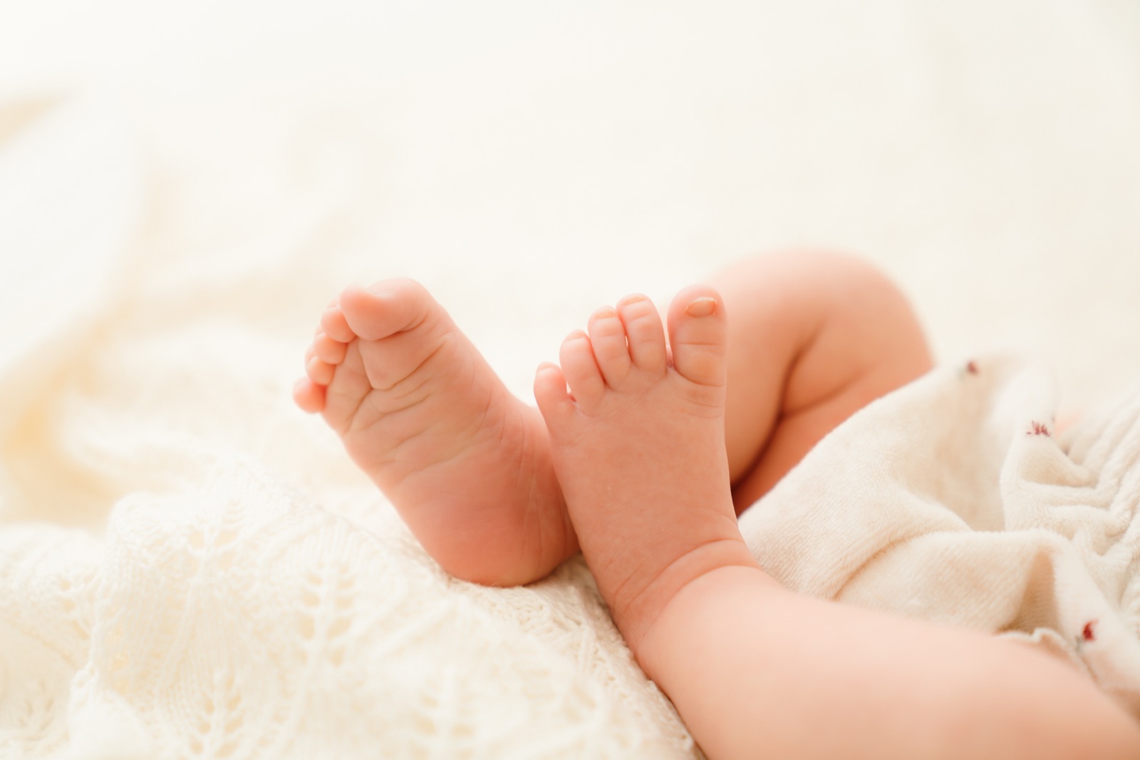 Kleng Bebesféiss op enger Strécklacken, Newborn Detailfoto zu Lëtzebuerg